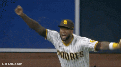 A Baseball Player Wearing A Padres Uniform Is Standing On The Field . GIF