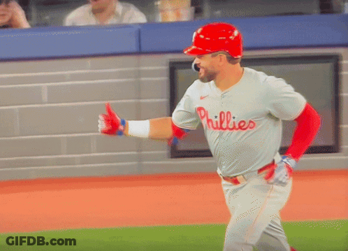 A Baseball Player Wearing A Phillies Jersey And A Red Helmet GIF