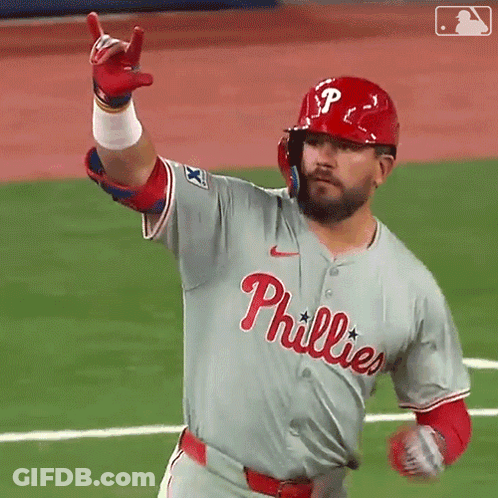 A Baseball Player Wearing A Phillies Jersey Is Pointing Up GIF