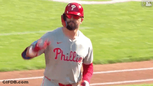 A Baseball Player Wearing A Phillies Jersey Is Running On The Field GIF
