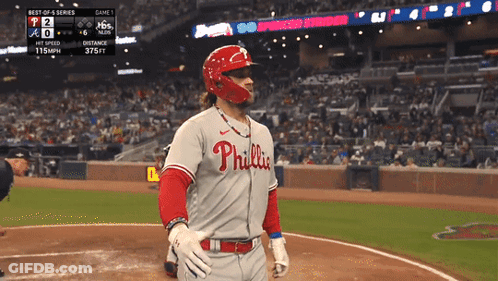 A Baseball Player Wearing A Phillies Jersey Is Standing On The Field GIF