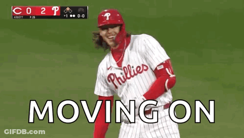 A Baseball Player Wearing A Phillies Uniform Is Standing On A Field . GIF