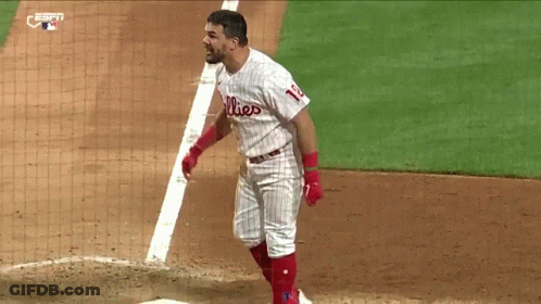 A Baseball Player Wearing A Phillies Uniform Is Standing On The Base GIF