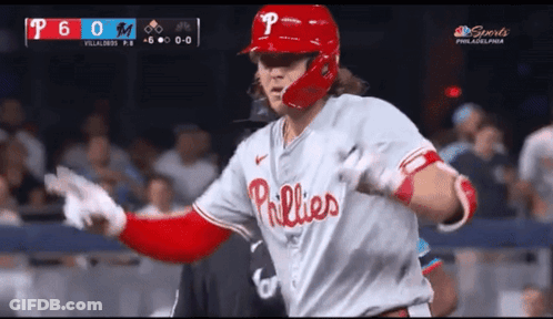 A Baseball Player Wearing A Phillies Uniform Runs Towards The Dugout GIF