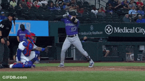 A Baseball Player Wearing A Purple Jersey With The Number 27 On It GIF