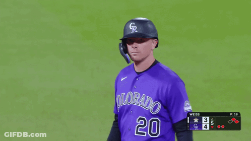 A Baseball Player Wearing A Purple Uniform With Colorado 20 On It GIF