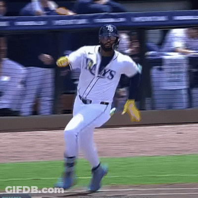 A Baseball Player Wearing A Rays Jersey Is Running Towards Home Plate GIF
