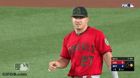 A Baseball Player Wearing A Red Angels Jersey Is Pointing GIF