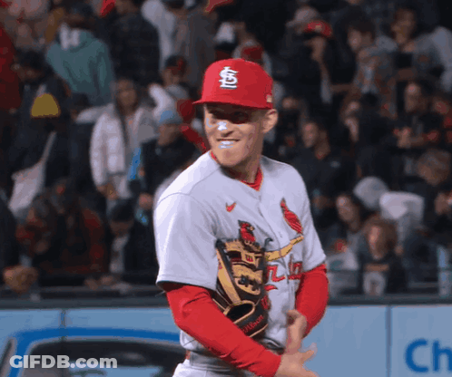 A Baseball Player Wearing A Red Cardinals Hat And Glove GIF