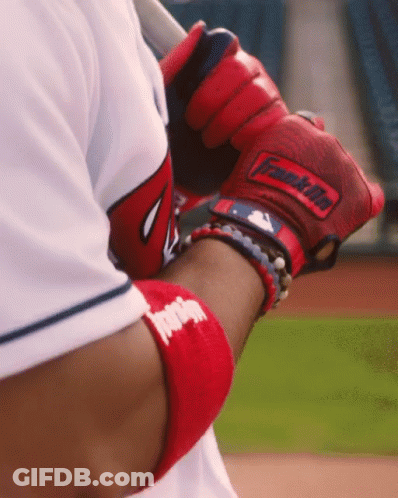 A Baseball Player Wearing A Red Franklin Glove Holds A Bat GIF