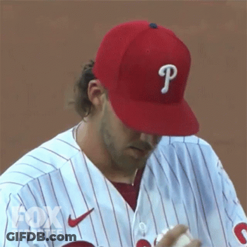 A Baseball Player Wearing A Red Hat With A Letter P On It GIF