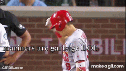 A Baseball Player Wearing A Red Helmet With The Words Mariners Are Garbage Lol GIF