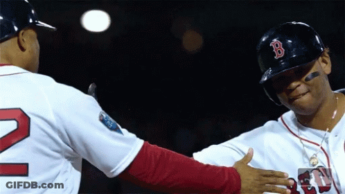 A Baseball Player Wearing A Red Sox Hat Is Shaking Hands With Another Player GIF
