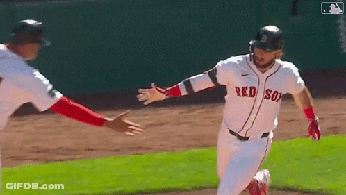 A Baseball Player Wearing A Red Sox Jersey Is Running On The Field . GIF