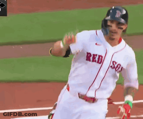 A Baseball Player Wearing A Red Sox Jersey Is Running Towards Home Plate GIF