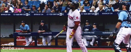 A Baseball Player Wearing A Red Sox Uniform Stands In Front Of A Dugout GIF