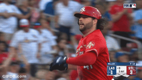 A Baseball Player Wearing A Red Uniform With The Letters Stl On It GIF