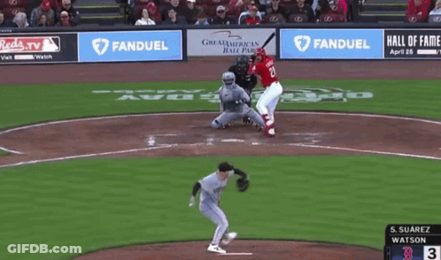 A Baseball Player Wearing A Reds Jersey Is Standing On The Field GIF