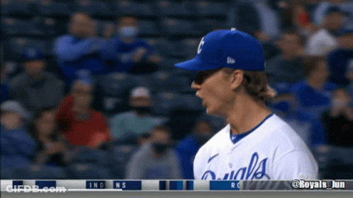 A Baseball Player Wearing A Royals Jersey Stands In The Dugout GIF
