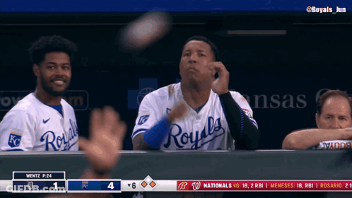 A Baseball Player Wearing A Royals Jersey Throws A Ball In The Air GIF
