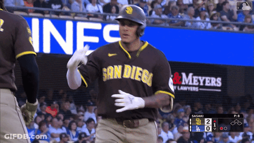 A Baseball Player Wearing A San Diego Jersey Stands In Front Of An Advertisement For Meyers GIF