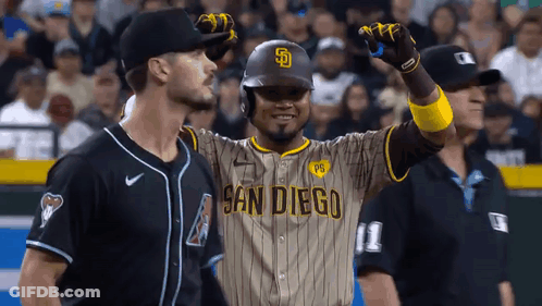 A Baseball Player Wearing A San Diego Uniform Is Standing Next To A Referee . GIF