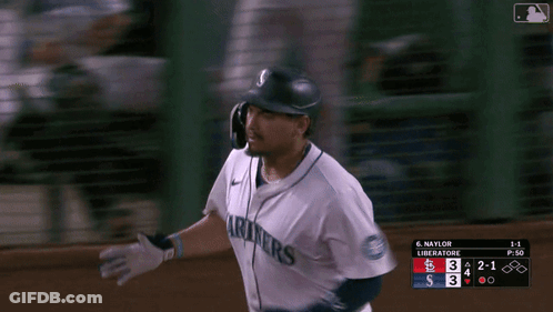 A Baseball Player Wearing A Seattle Mariners Jersey Runs Towards Home Plate GIF