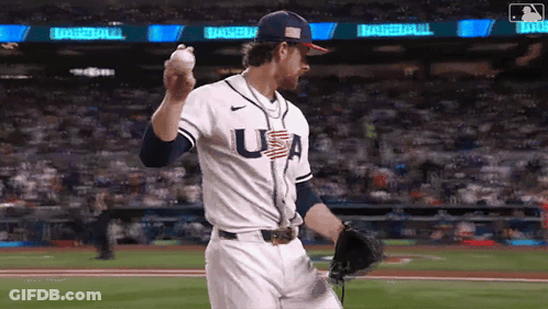 A Baseball Player Wearing A Usa Jersey Is Throwing A Baseball . GIF