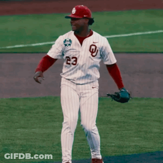 A Baseball Player Wearing A White Jersey With A Red Letter L On It GIF