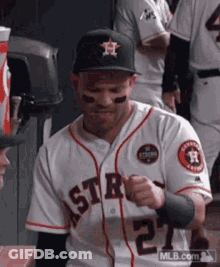 A Baseball Player Wearing A White Jersey With The Number 2 On It GIF