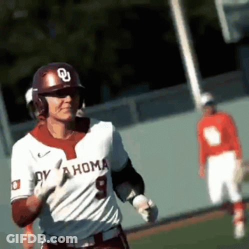 A Baseball Player Wearing A White Oklahoma Jersey Is Running On The Field GIF