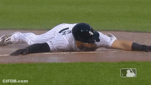 A Baseball Player Wearing A White Sox Uniform Is Laying On The Ground GIF
