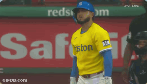 A Baseball Player Wearing A Yellow And Blue Boston Jersey GIF