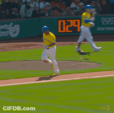 A Baseball Player Wearing A Yellow Jersey That Says Boston Is Running On The Field GIF