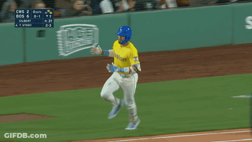 A Baseball Player Wearing A Yellow Jersey That Says Boston On It GIF