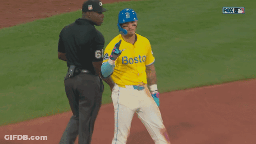 A Baseball Player Wearing A Yellow Jersey With Boston On It GIF