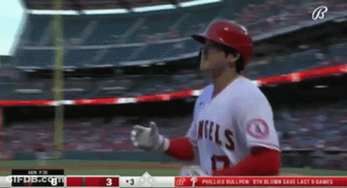A Baseball Player Wearing An Angels Jersey Is Standing On The Field GIF