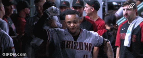 A Baseball Player Wearing An Arizona Jersey Stands In A Locker Room GIF