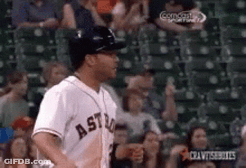 A Baseball Player Wearing An Astros Jersey Is Running In Front Of A Crowd . GIF