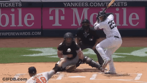 A Baseball Player Wearing Number 23 Is Swinging At A Ball GIF