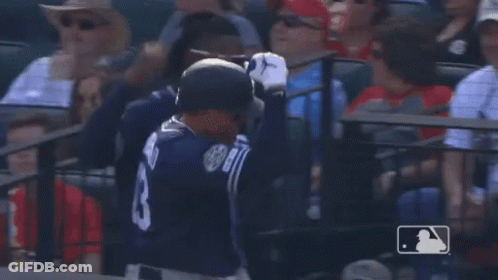 A Baseball Player Wearing Sunglasses And A Jersey With The Number 7 On It Is Talking To Another Player . GIF