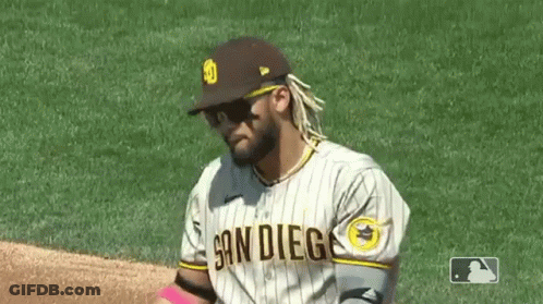 A Baseball Player Wearing Sunglasses And A San Diego Jersey Is Standing On The Field . GIF