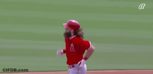 A Baseball Player With A Beard Is Running On A Baseball Field . GIF