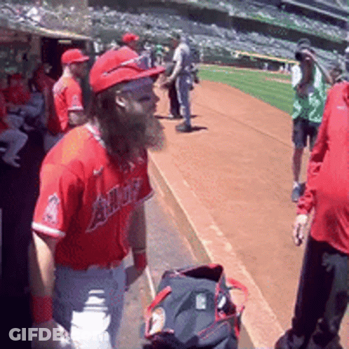 A Baseball Player With A Beard Wearing A Red Angels Jersey GIF
