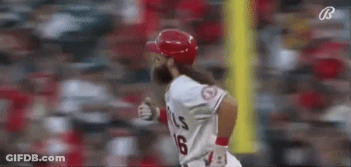 A Baseball Player With A Long Beard Is Running Towards Home Plate During A Game . GIF