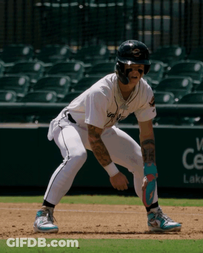 A Baseball Player With A Tattoo On His Arm Stands On The Base GIF
