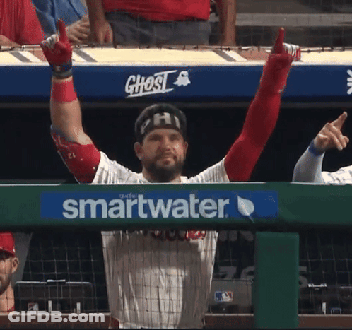 A Baseball Player With His Arms In The Air Behind A Smartwater Advertisement GIF