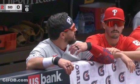 A Baseball Player With The Letter P On His Hat Talks To Another Player GIF