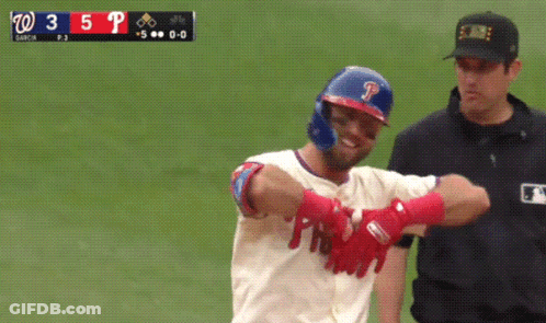 A Baseball Player With The Letter P On His Helmet Stands Next To A Referee GIF