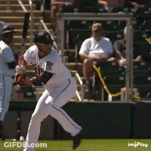 A Baseball Player With The Letter T On His Jersey Swings At A Pitch GIF